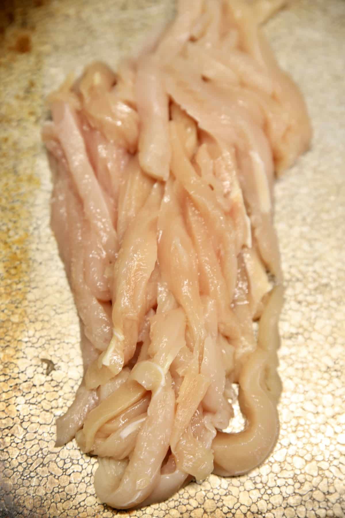 Thin sliced chicken tenders for chicken fries.