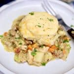 Chicken and biscuits casserole on a plate with a fork.