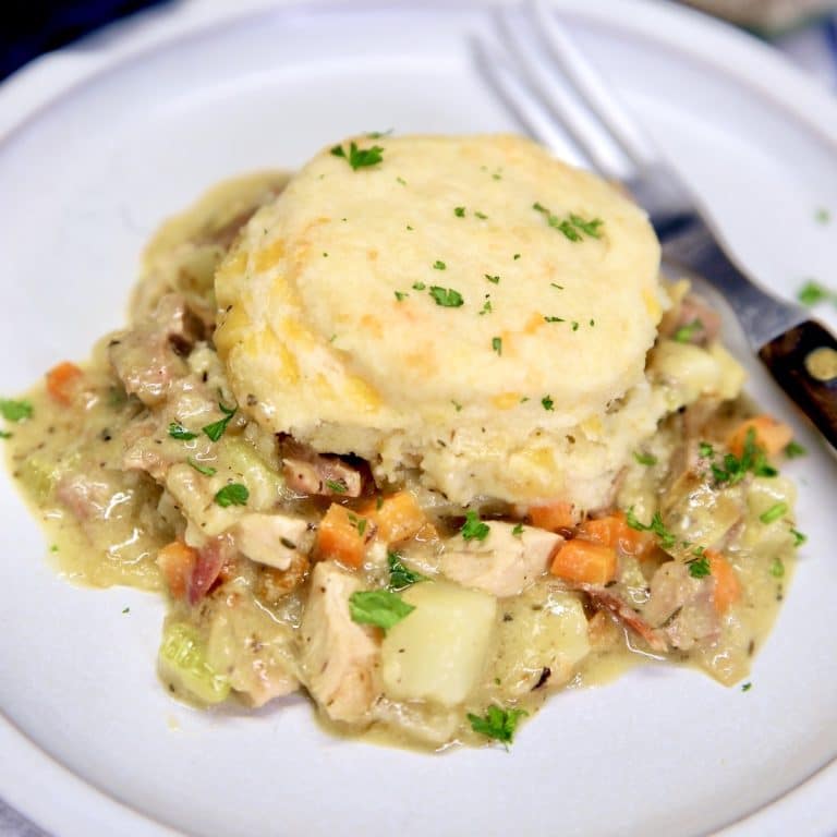 Chicken and biscuits casserole on a plate with a fork.