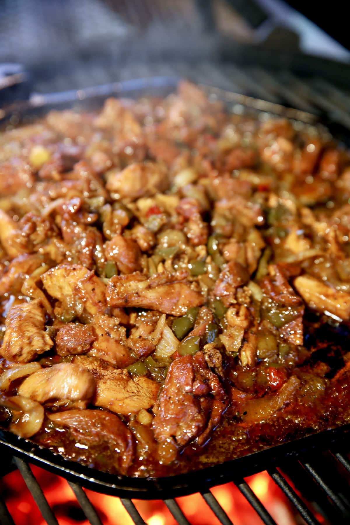 Cooking chicken fajitas on a grill.