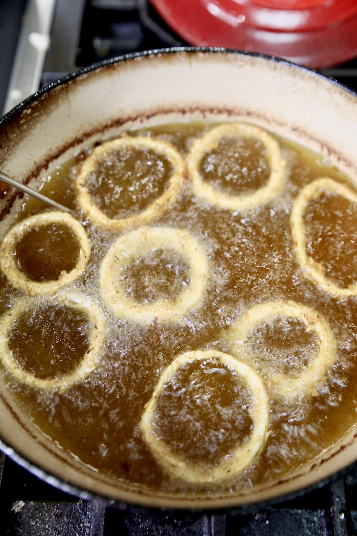 Frying onion rings in a dutch oven.