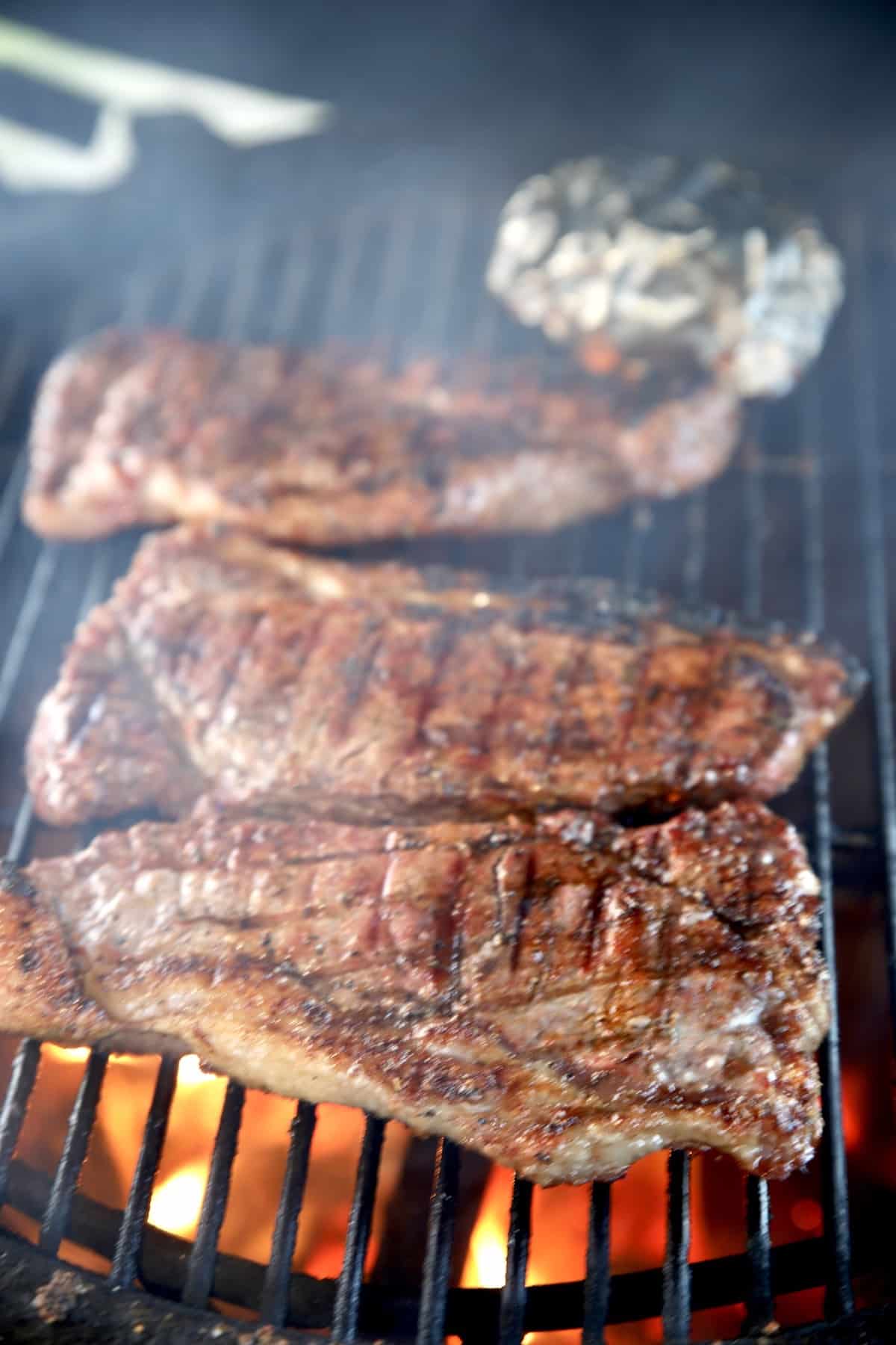 Grilling NY Strip Steak with dry rub.