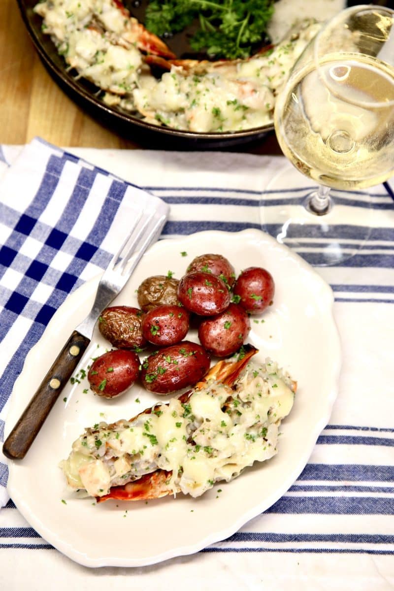 Oval plate with lobster Thermidor and baby red potatoes.