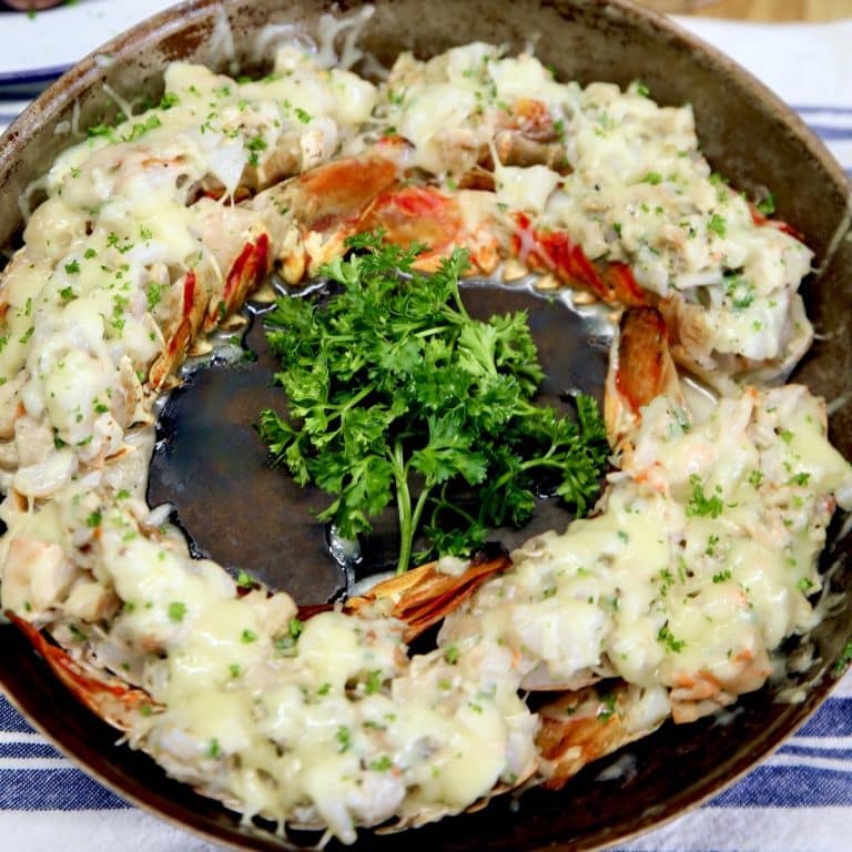 Lobster Thermidor in a skillet with parsley in center.
