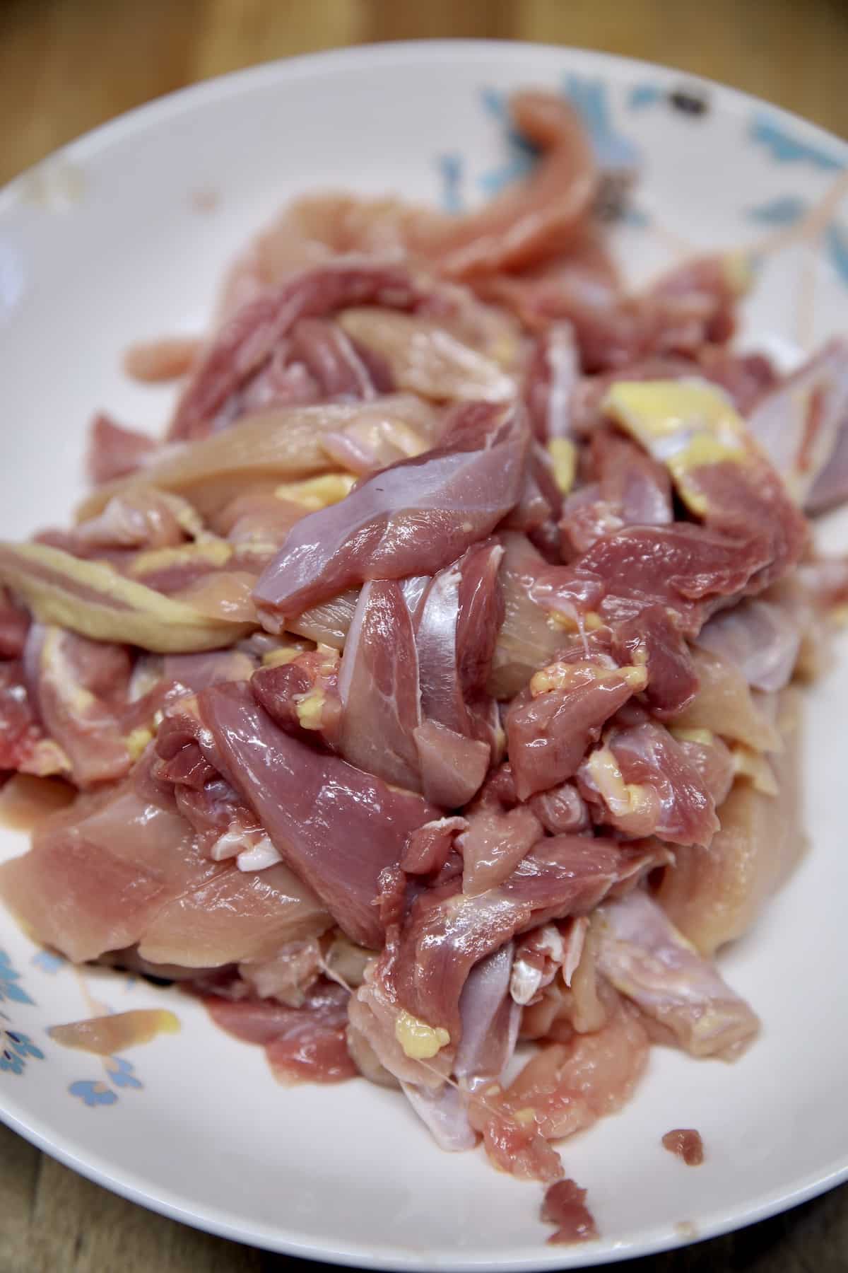 Sliced boneless chicken in a bowl. 