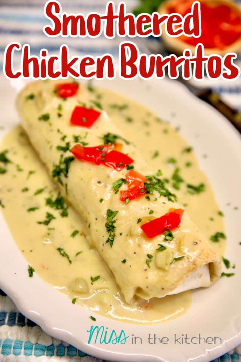 Smothered chicken burritos with tomatoes and cilantro.