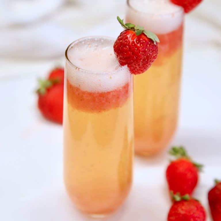 Strawberry Mimosas with strawberry garnish.