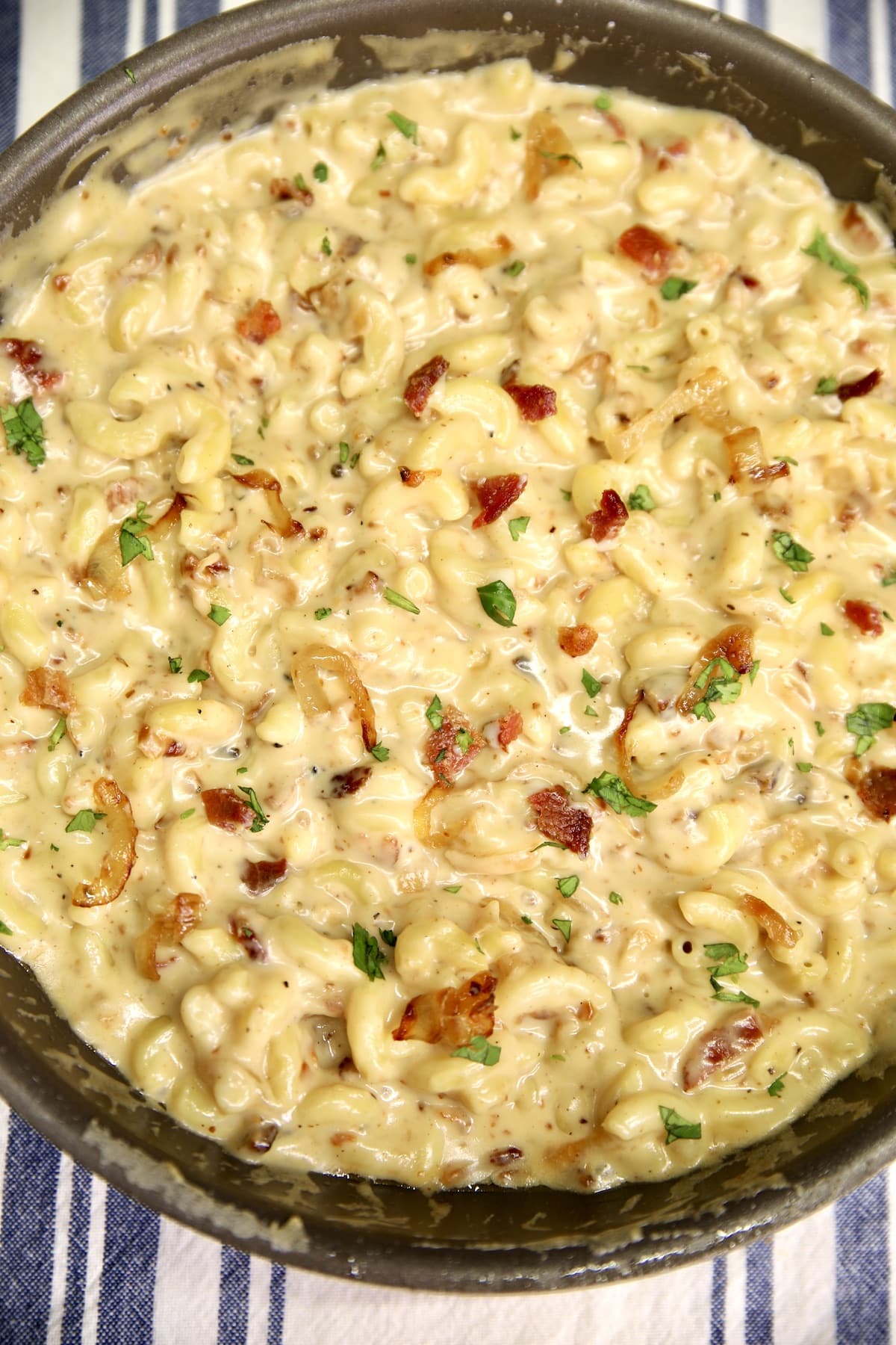 Pan of French Onion Mac and Cheese with crispy bacon.