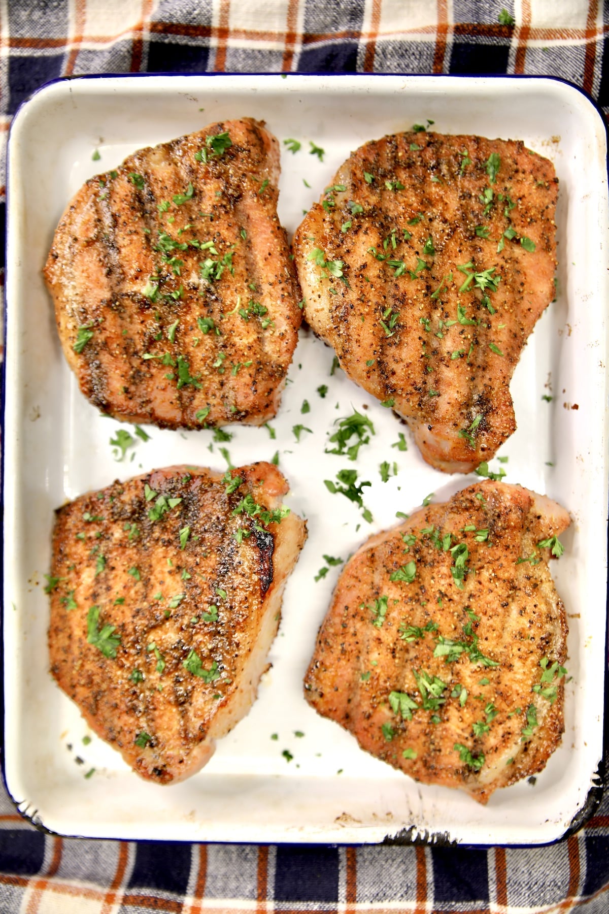 Platter of 4 grilled pork chops.