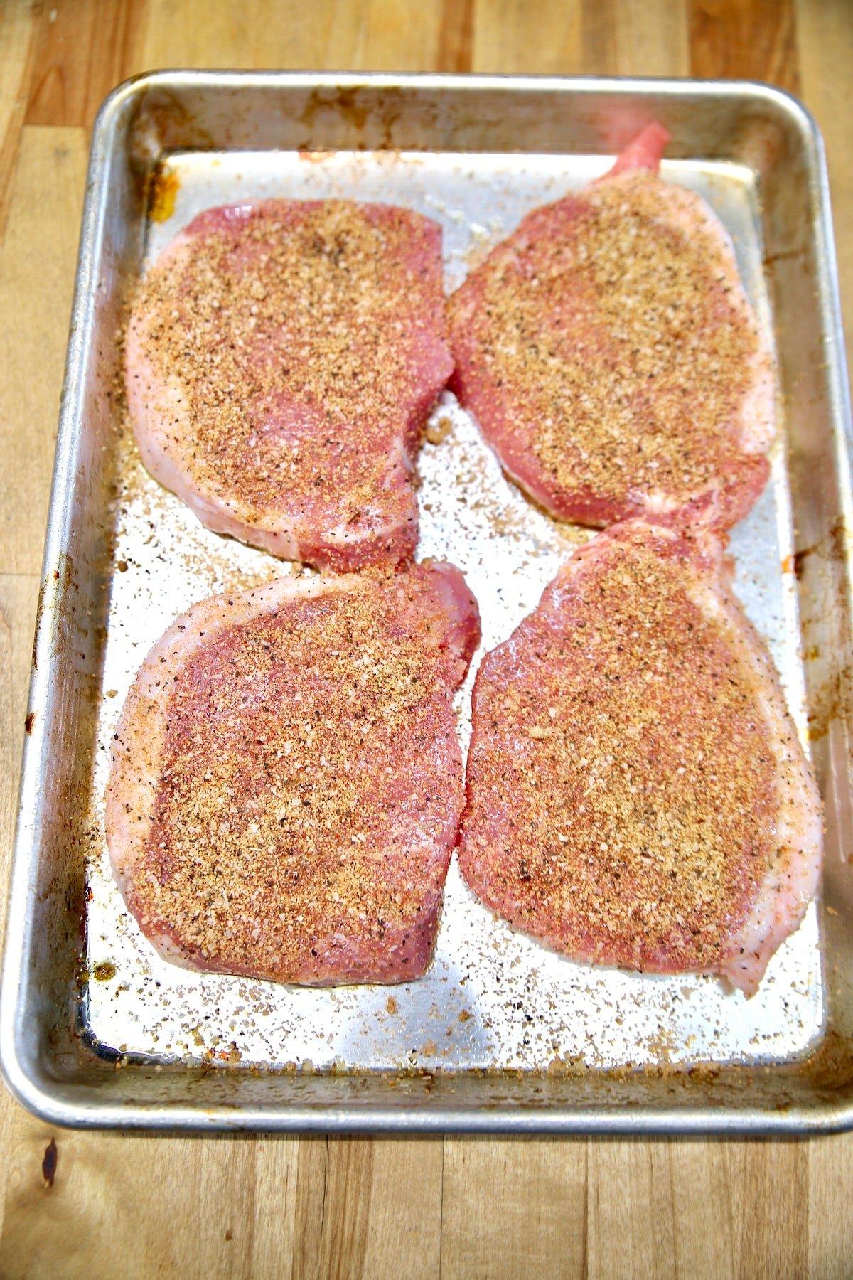 Dry rub seasoned pork chops ready to cook. 