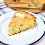 Slice of jalapeño cheddar cornbread with melting butter on top.