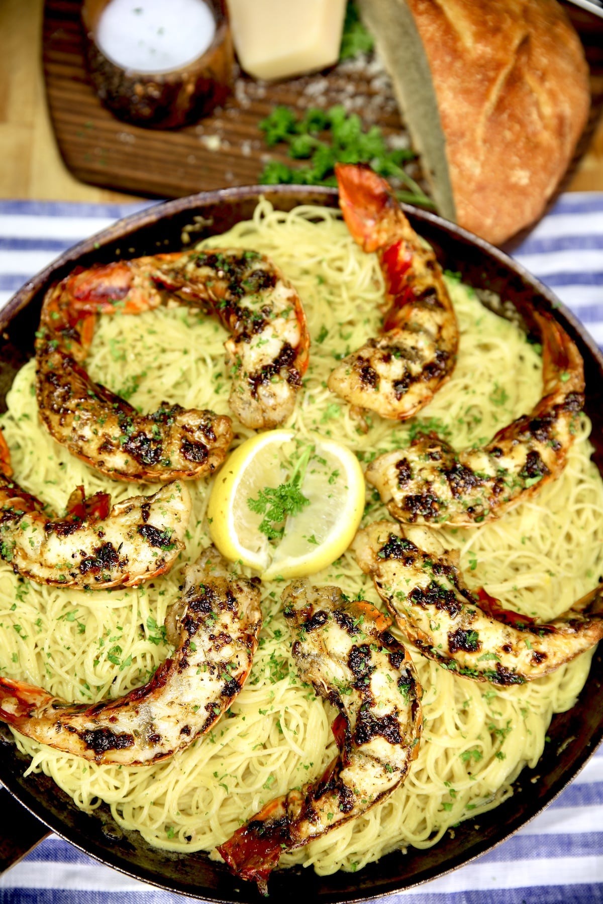 Skillet of lemon pasta topped with grilled lobster tails.