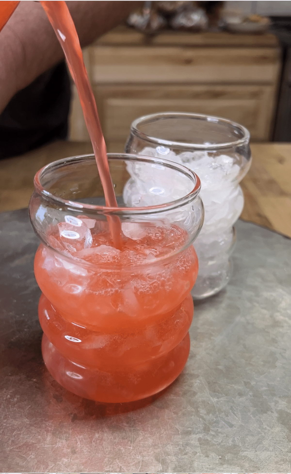 Filling glasses with red punch.
