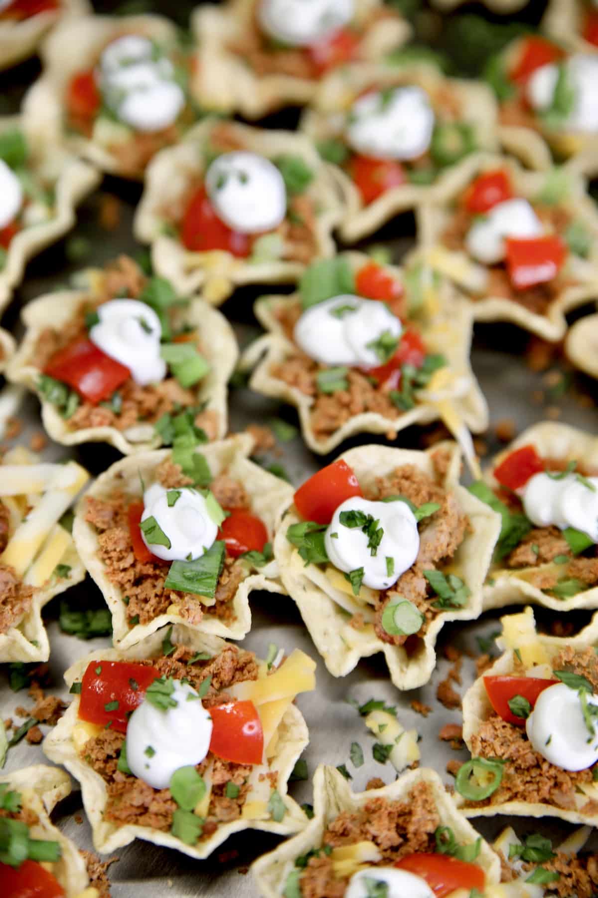 Venison Taco Bites with tomatoes and sour cream.