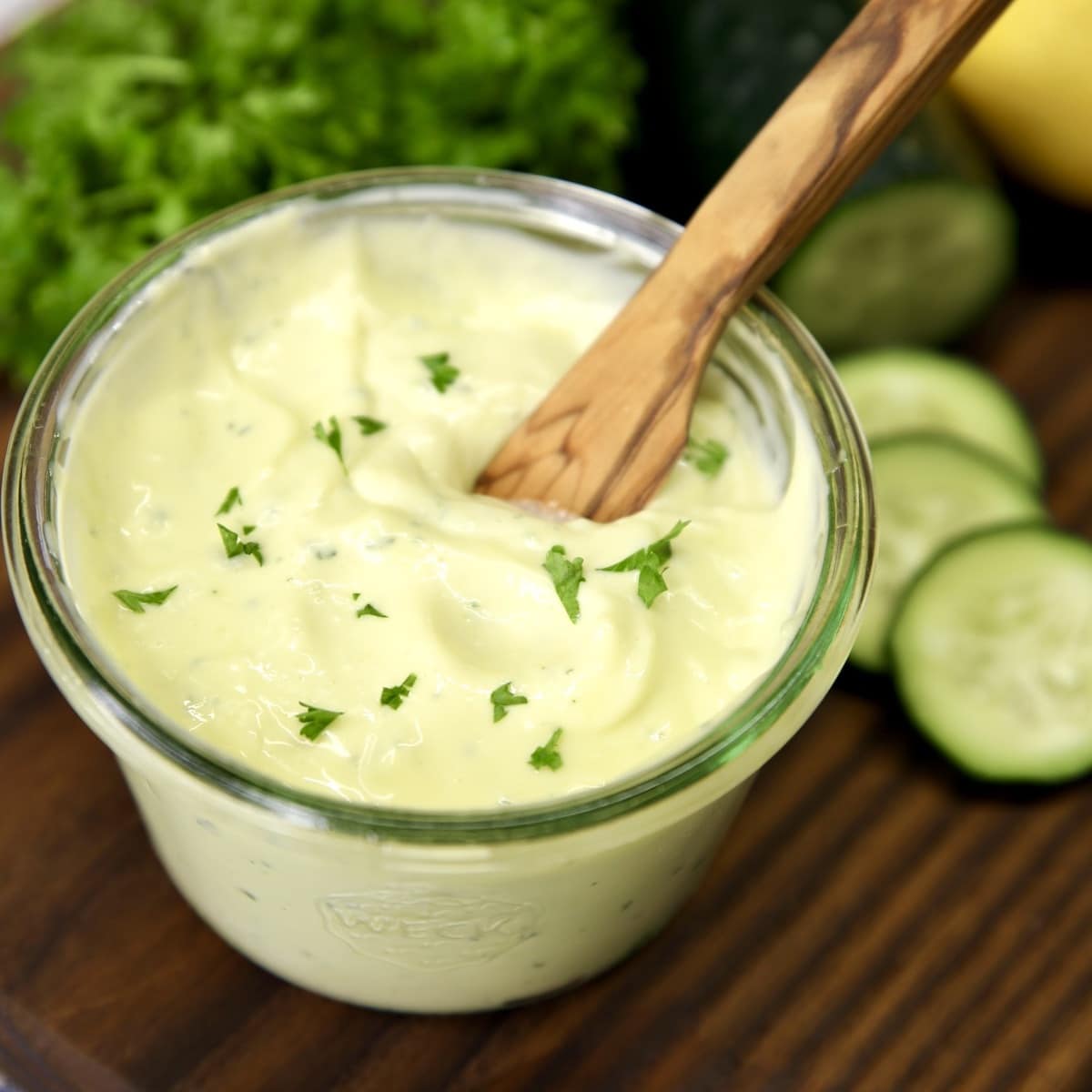 Homemade mayo with a wood knife in the jar.