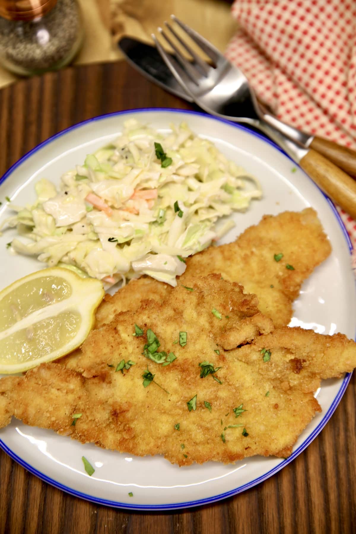 Plate of pork schnitzel with coleslaw.