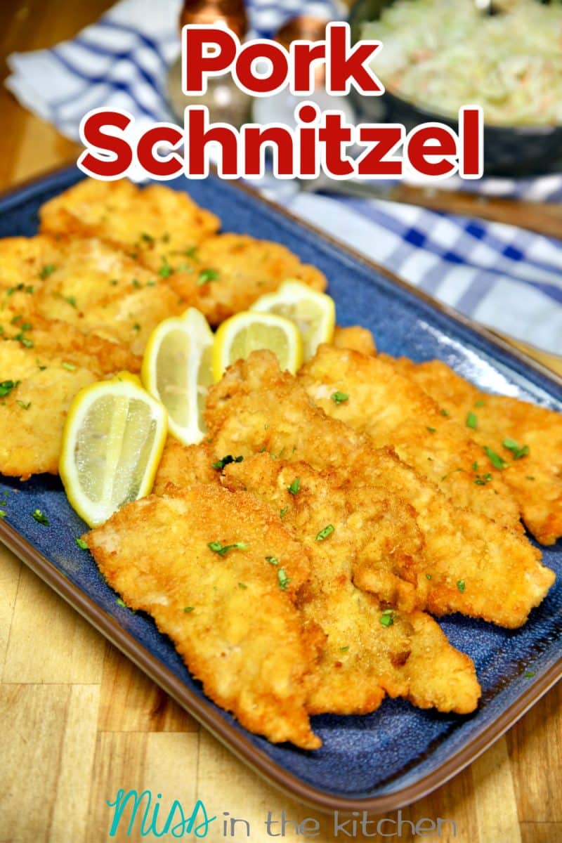 Platter of pork schnitzel with lemons. Text overlay.