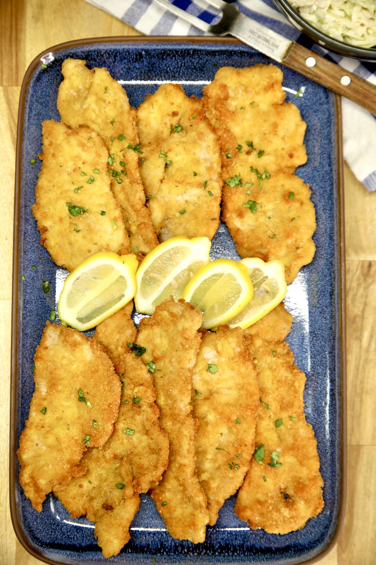 Platter of German Pork Schnitzel with lemon slices.
