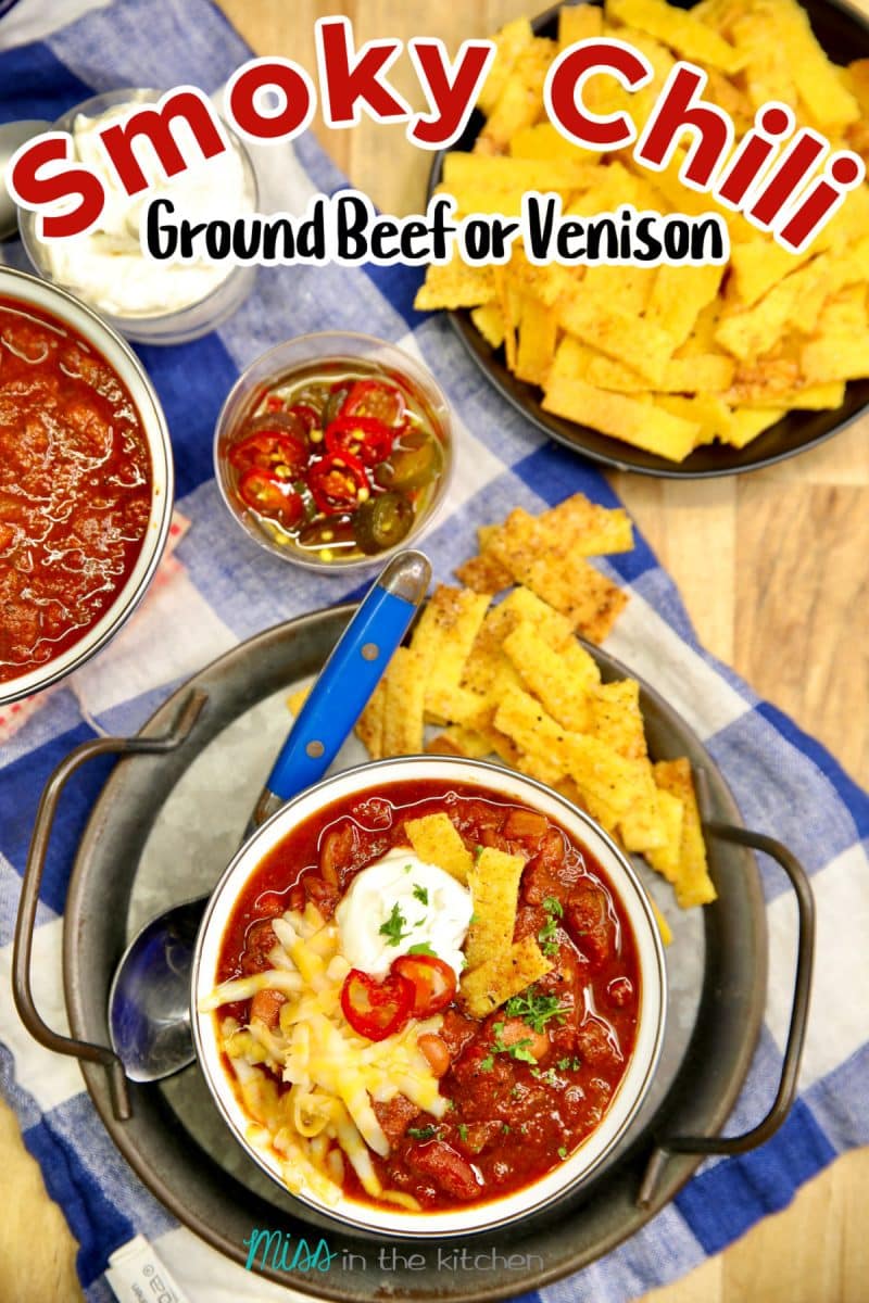 Smoky chili in a bowl with toppings, text overlay.
