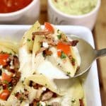 Brisket Stuffed Shells spooned out of casserole dish.