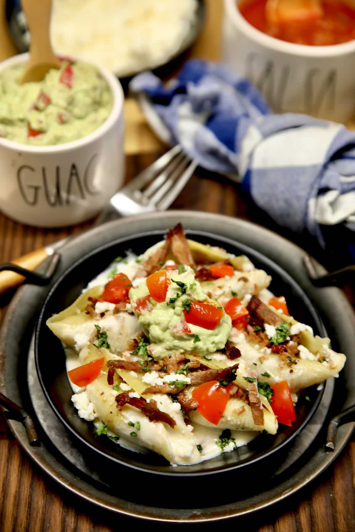 Brisket stuffed shells with sour cream sauce in a bowl.