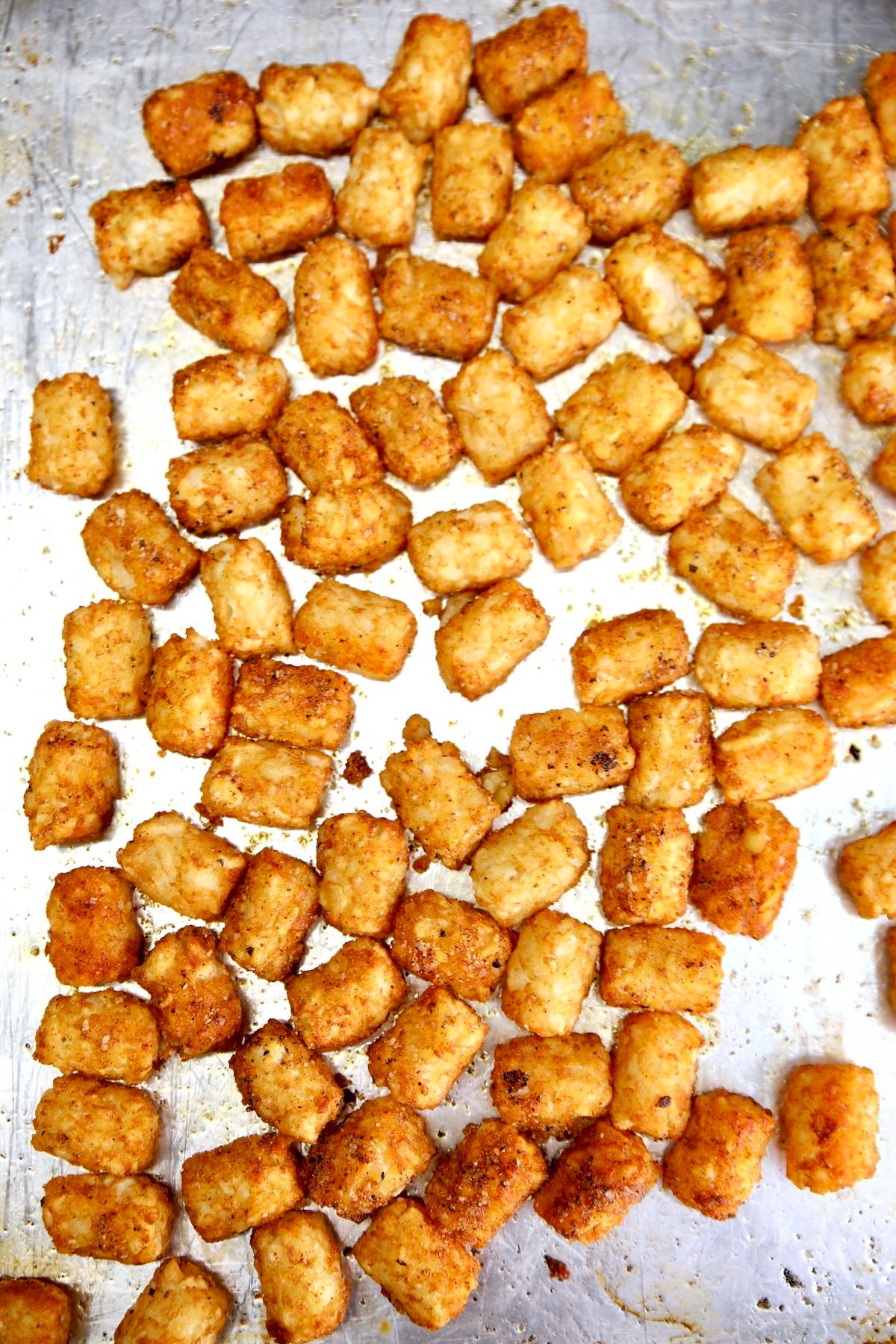 Crispy tater tots on a baking sheet.