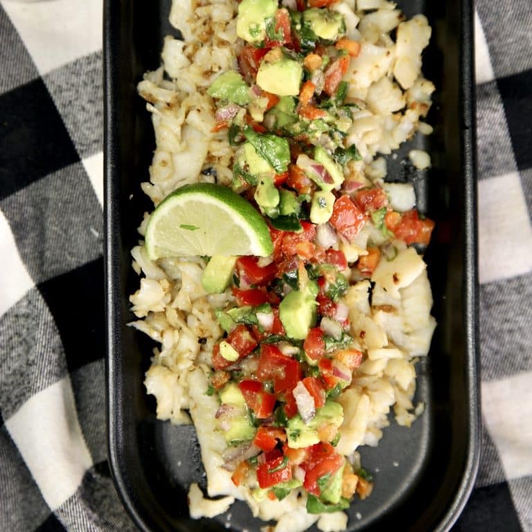 Platter with fish topped with avocado salsa.
