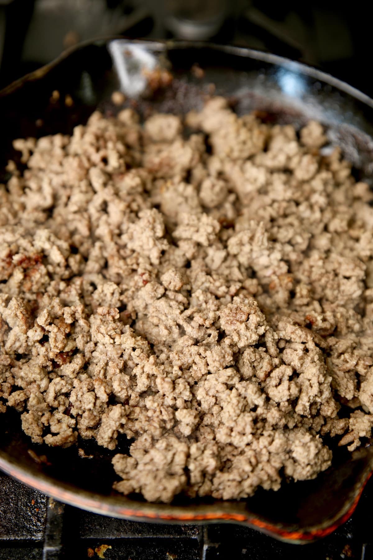 Browned ground beef in a skillet.