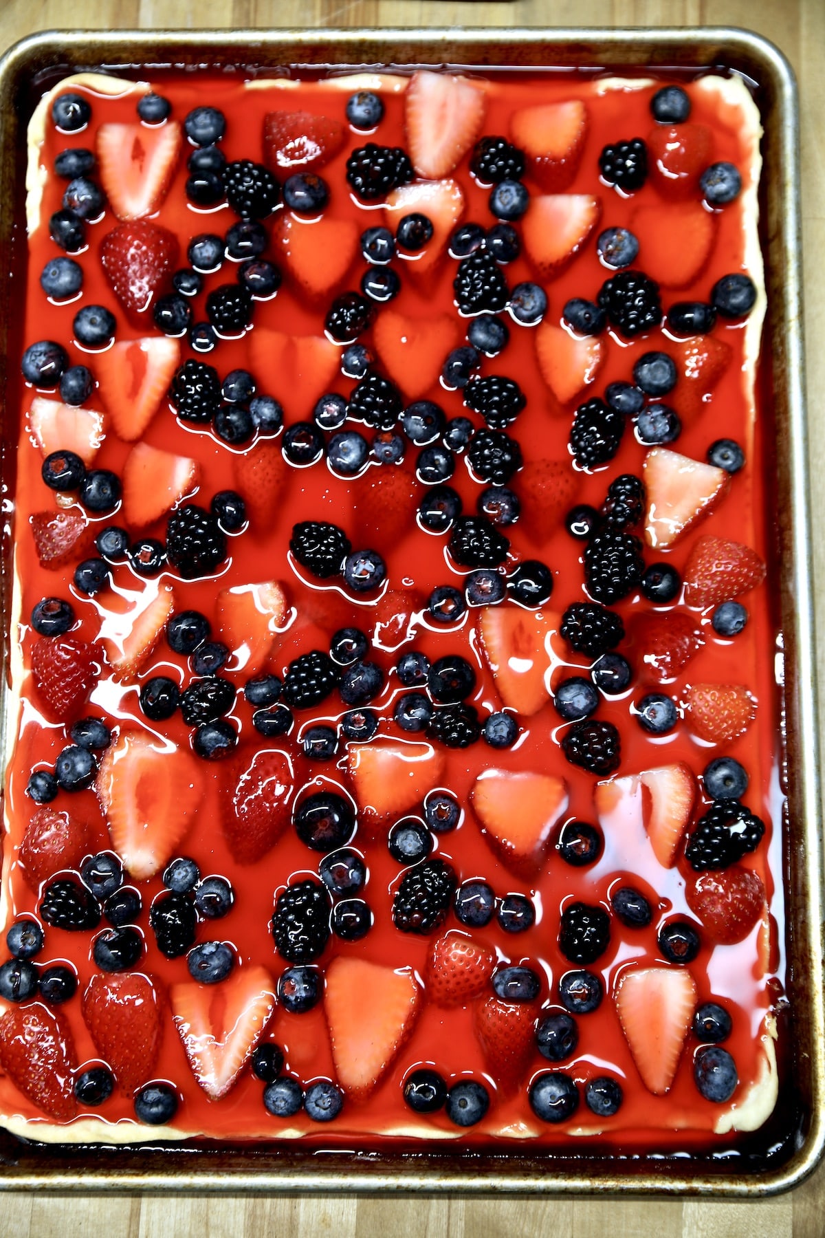 Strawberry, blueberry, blackberry Jello pie in a sheet pan.