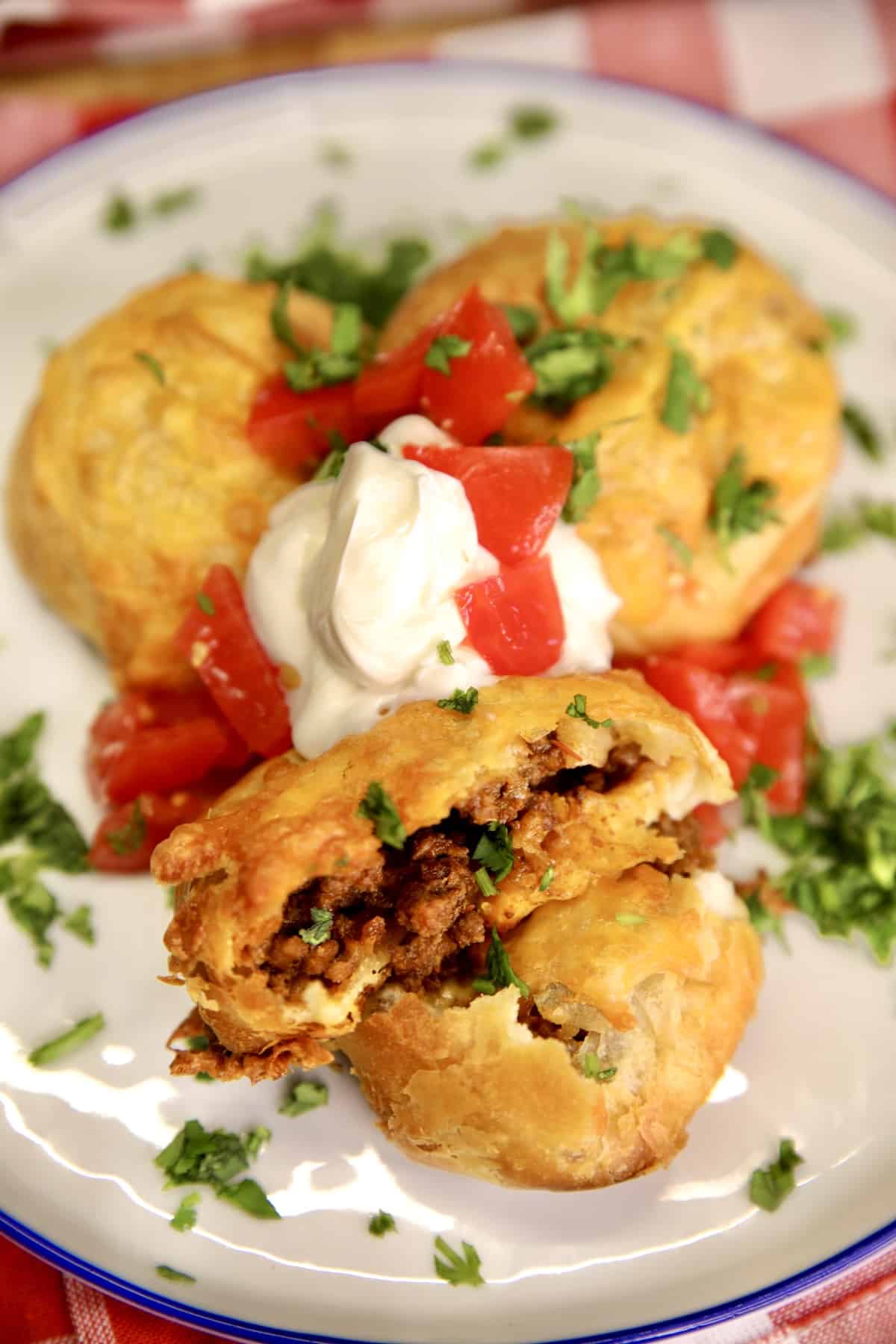 Taco Bombs with ground beef, cheese and refrigerated biscuits. Taco bombs with sour cream, tomatoes, cilantro.