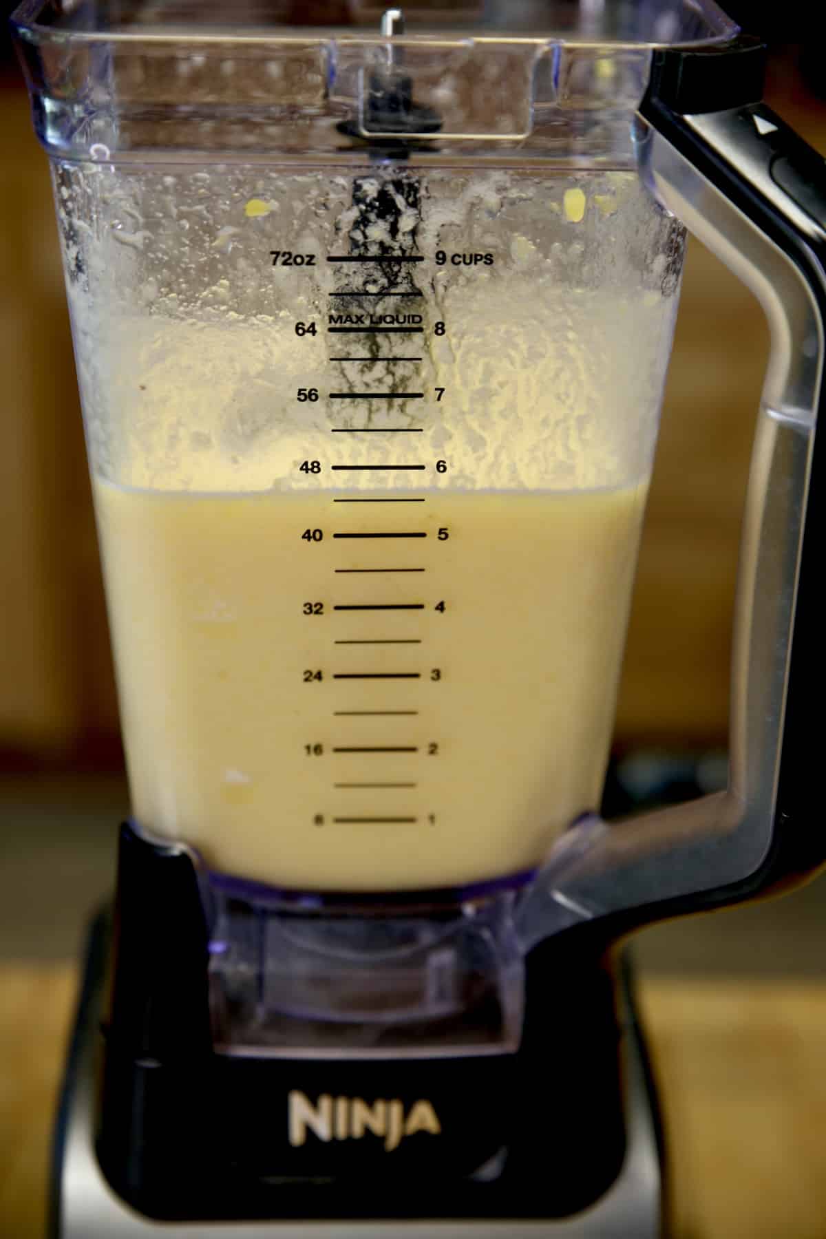 Blended peaches, pineapple and lemonade in a blender.