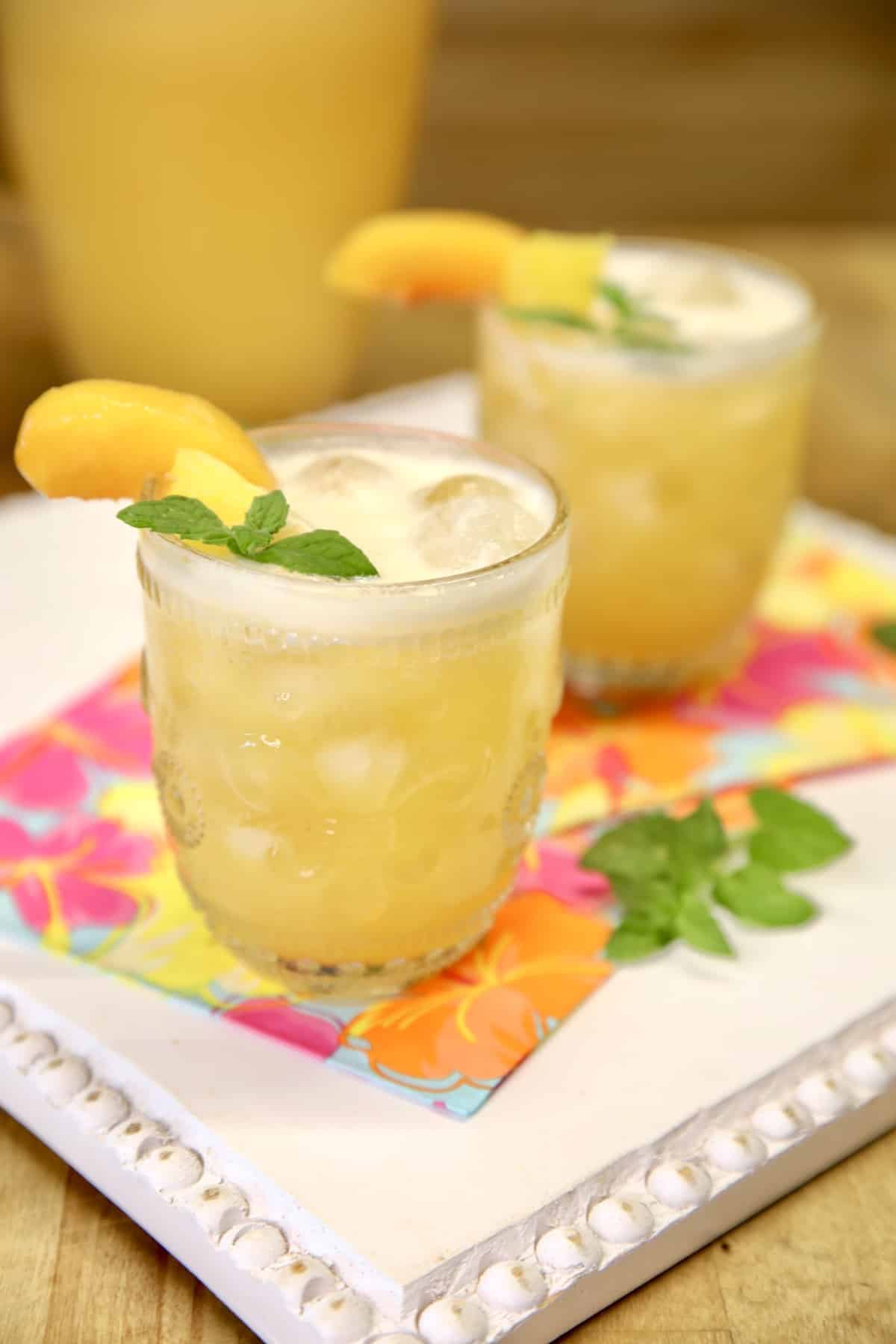 2 glasses of pineapple peach wine punch.
