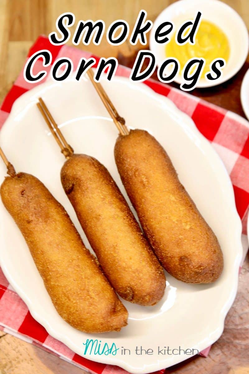 3 corn dogs on a platter, bowl of mustard - text overlay.