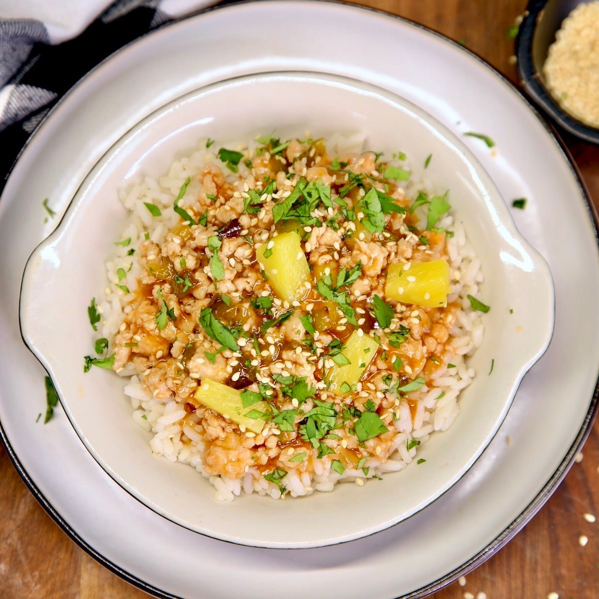 Sweet and Sour Ground Pork with pineapple and rice in a bowl.