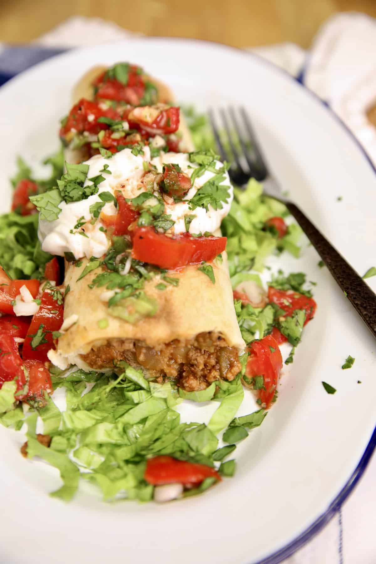 Beef and bean burrito with lettuce, sour cream, pico de gallo.