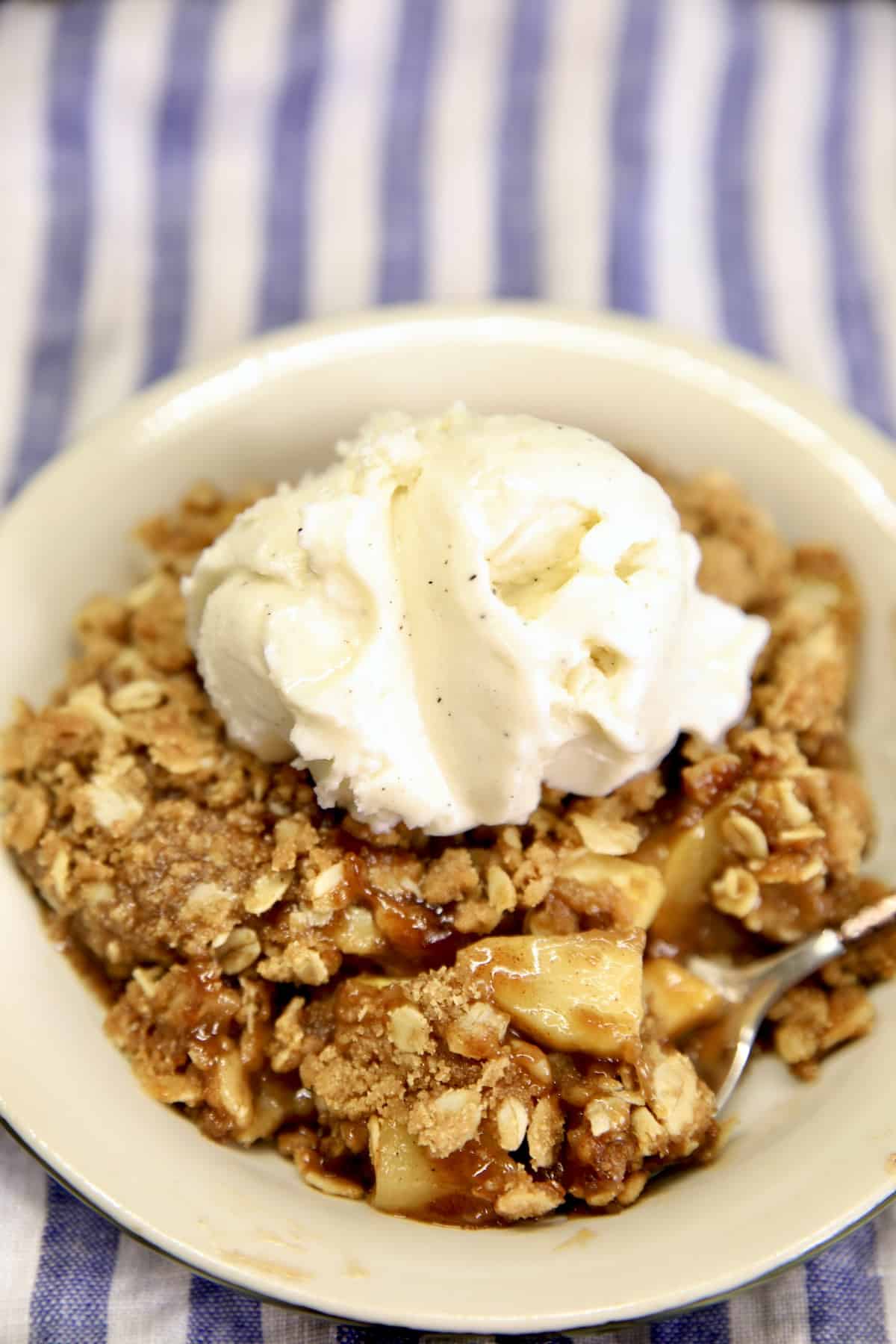 Mock apple crisp with zucchini. Bowl of zucchini crisp with vanilla ice cream.