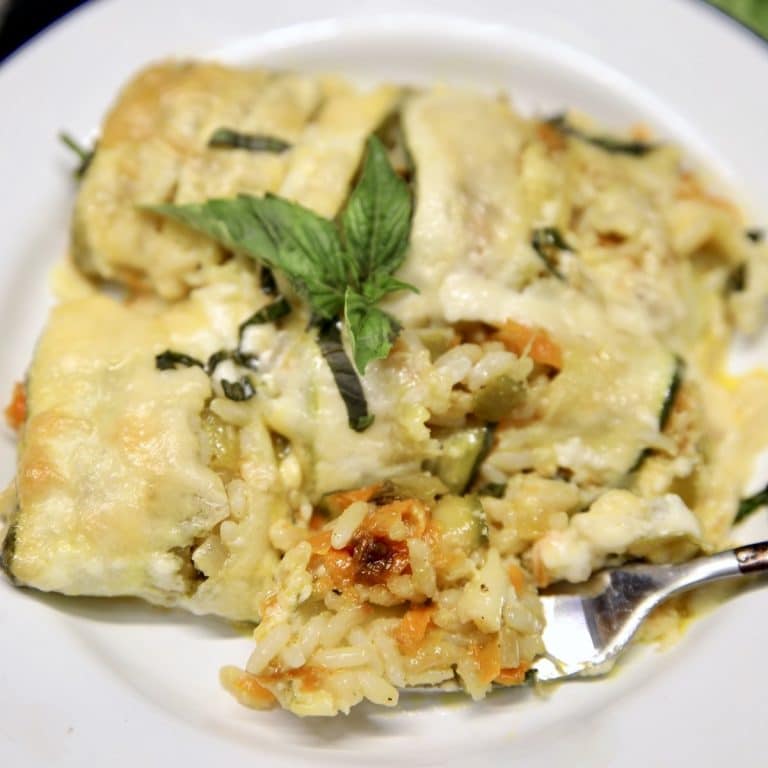Zucchini rice casserole with a fork on a plate.