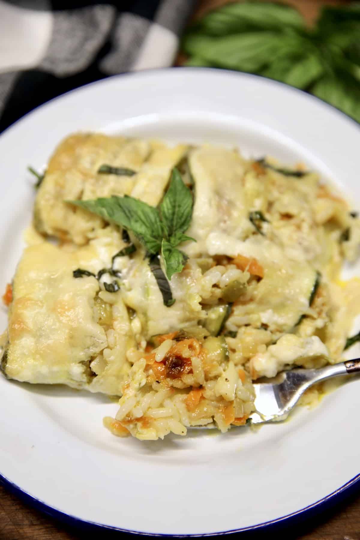 Zucchini rice casserole on a plate with a fork.
