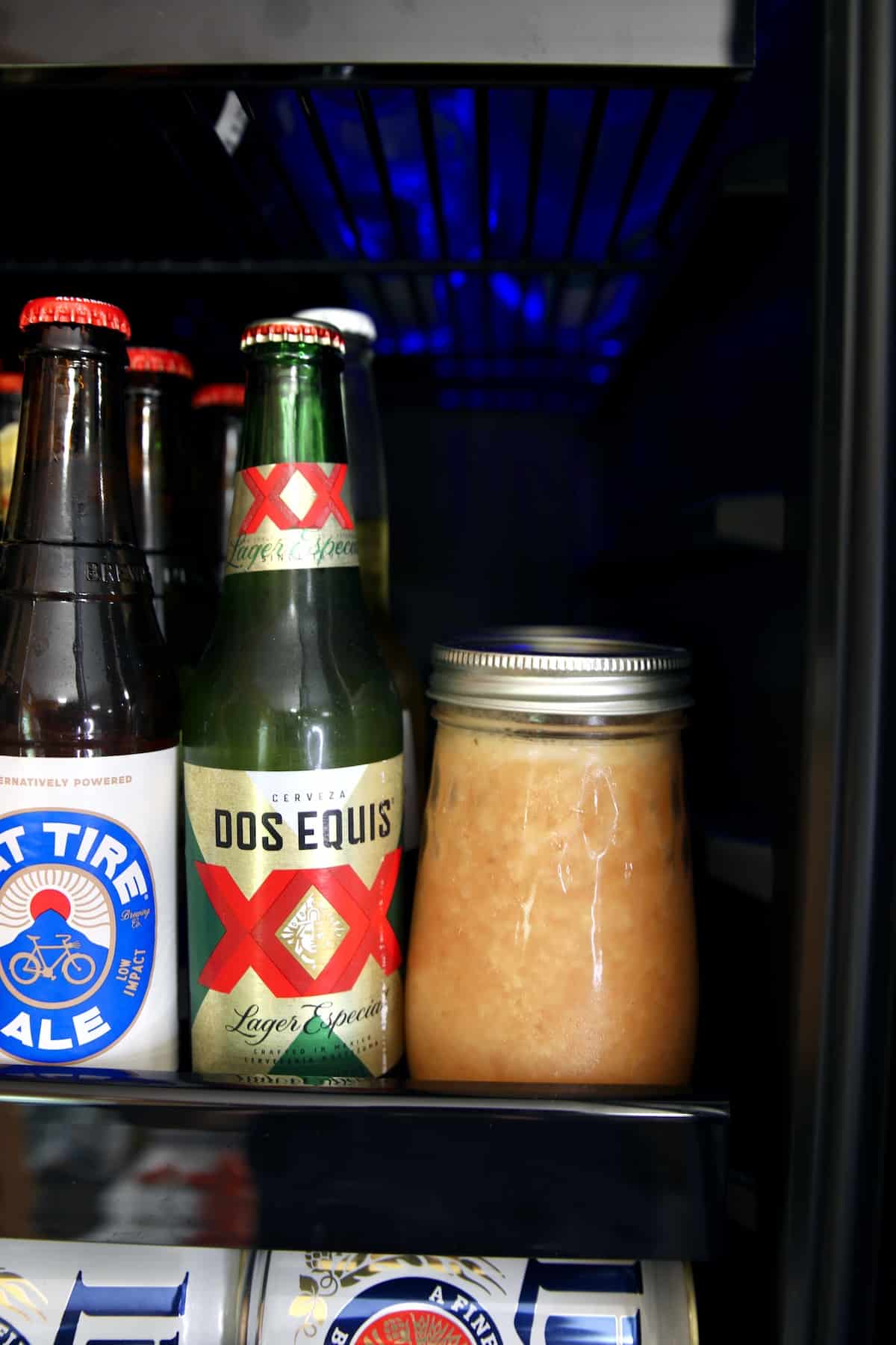 Close up of homemade wine coolers in beer fridge.
