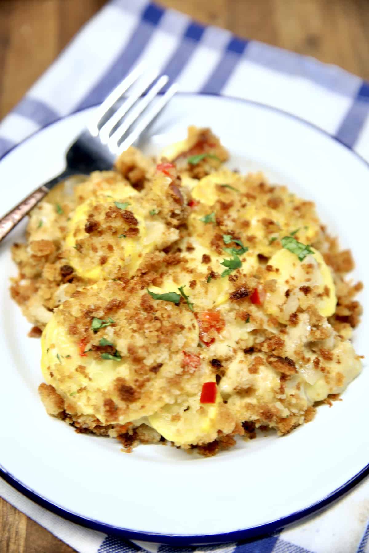 Cheesy squash casserole on a plate.