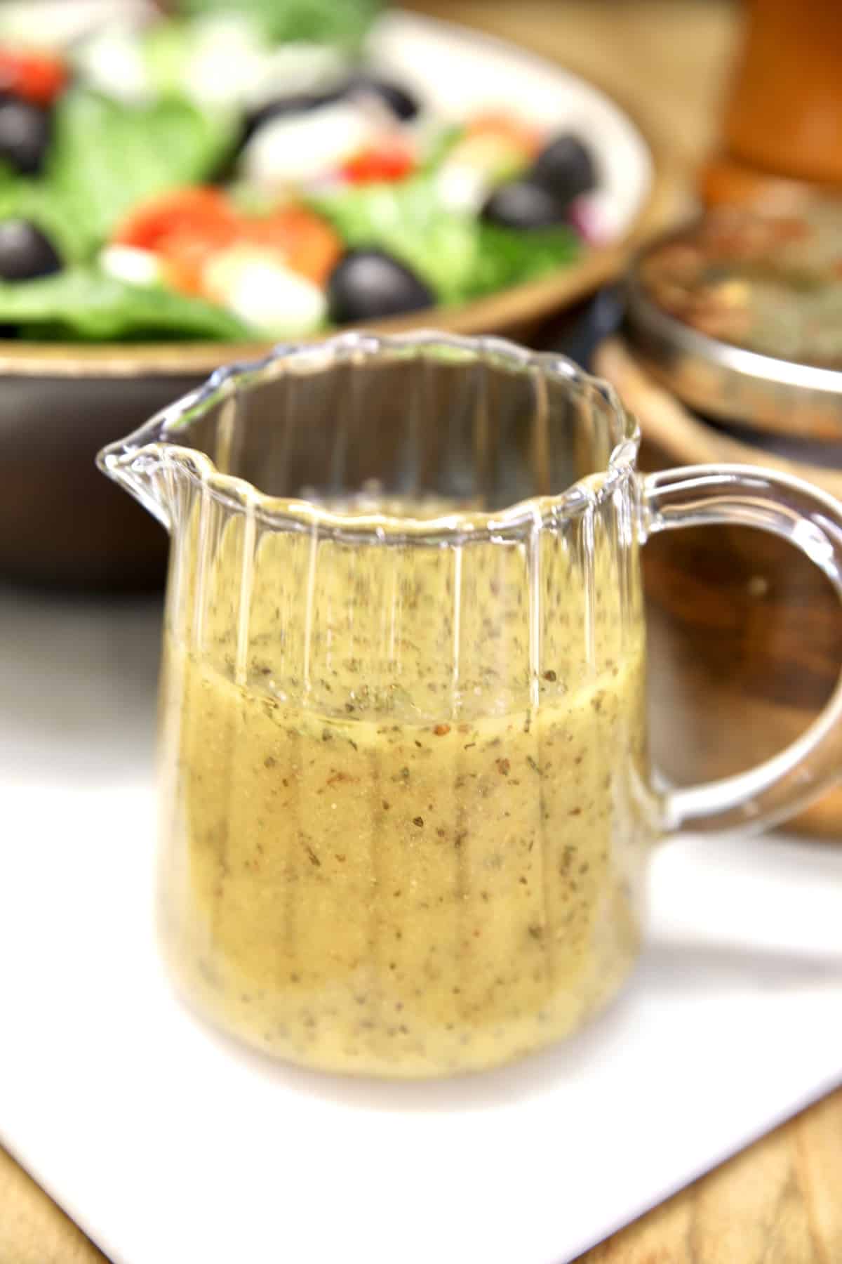 Easy Italian Dressing recipe. Pitcher of Italian salad dressing.