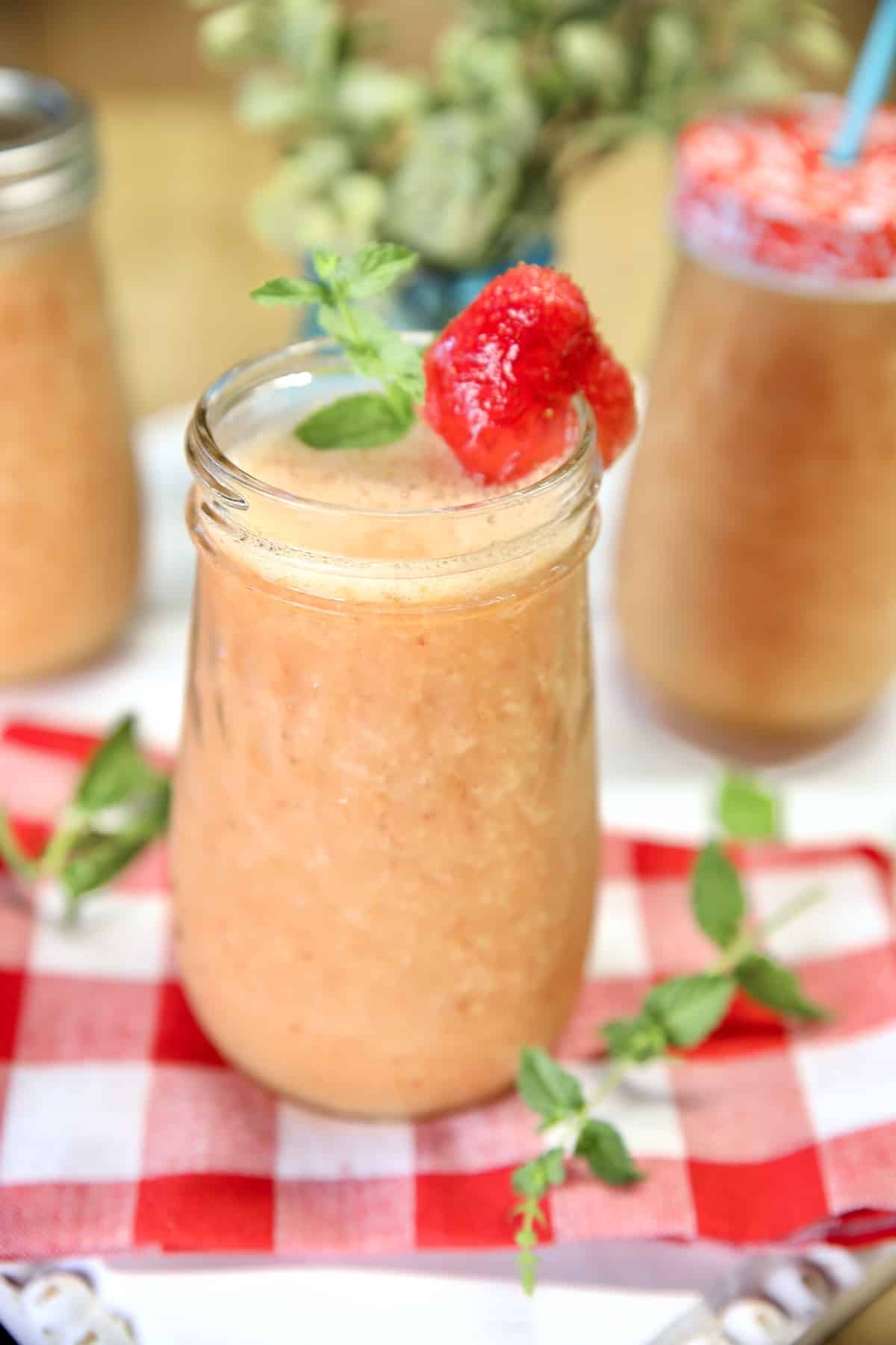 Strawberry mango wine coolers in mason jars.