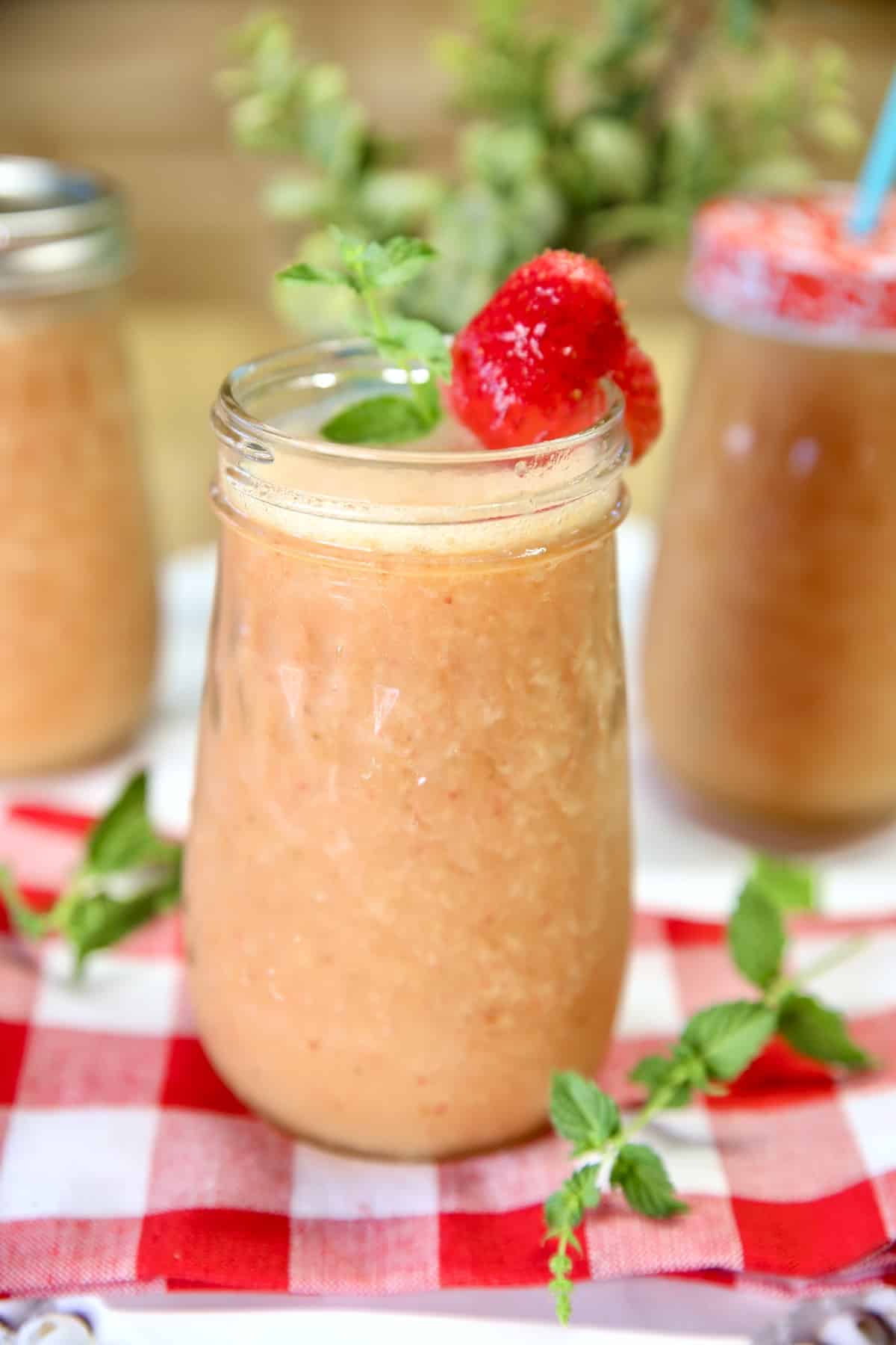 Strawberry mango wine coolers in mason jars.