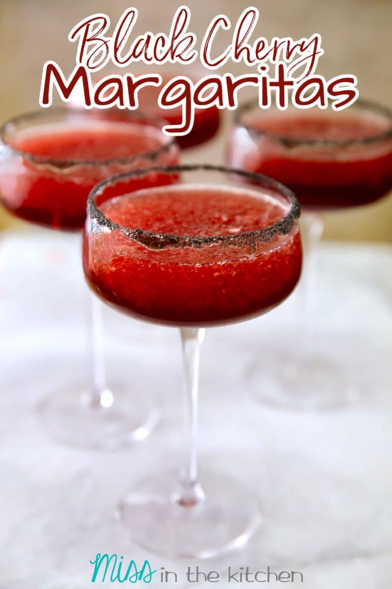 Black cherry margaritas in 4 glasses - text overlay.