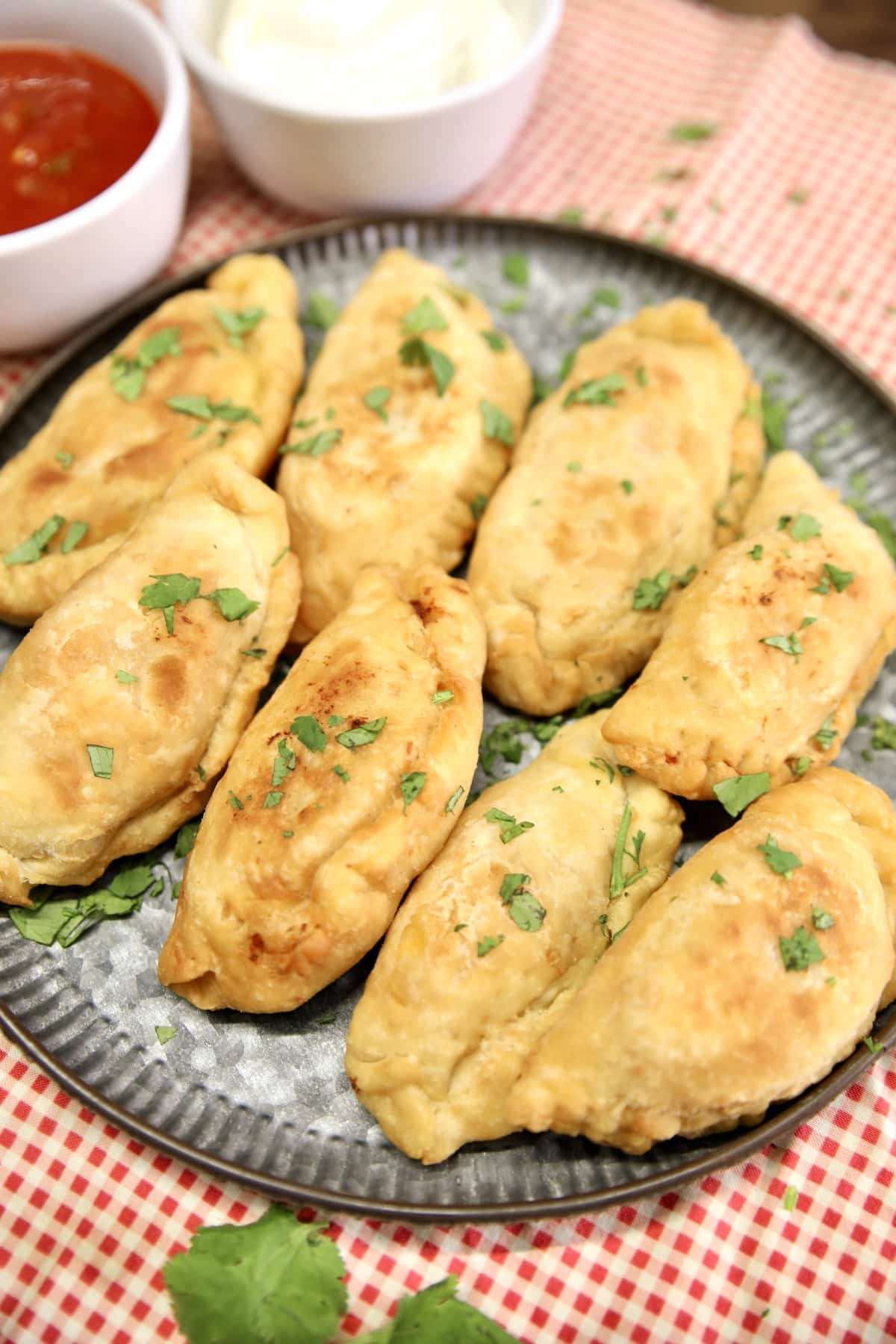 Platter of fried chicken empanadas.
