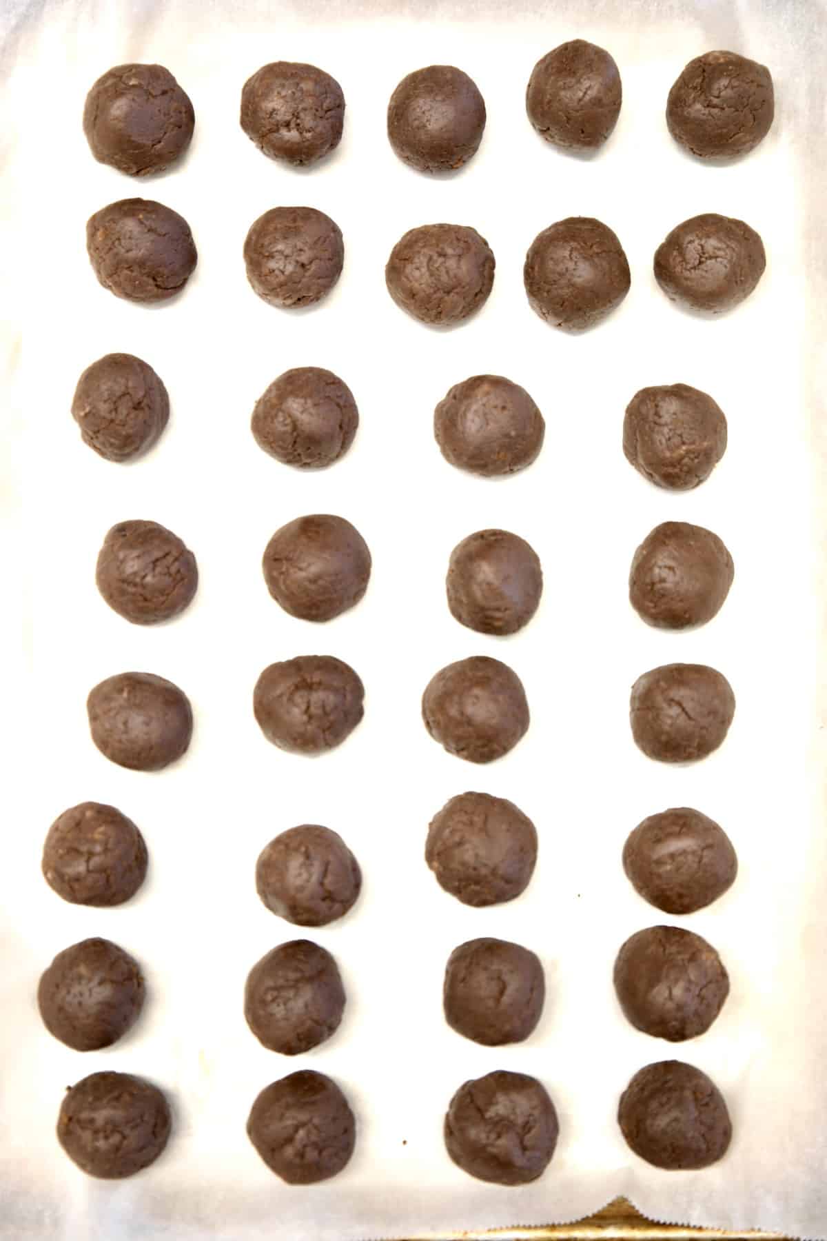 Chocolate cake balls on a sheet pan.