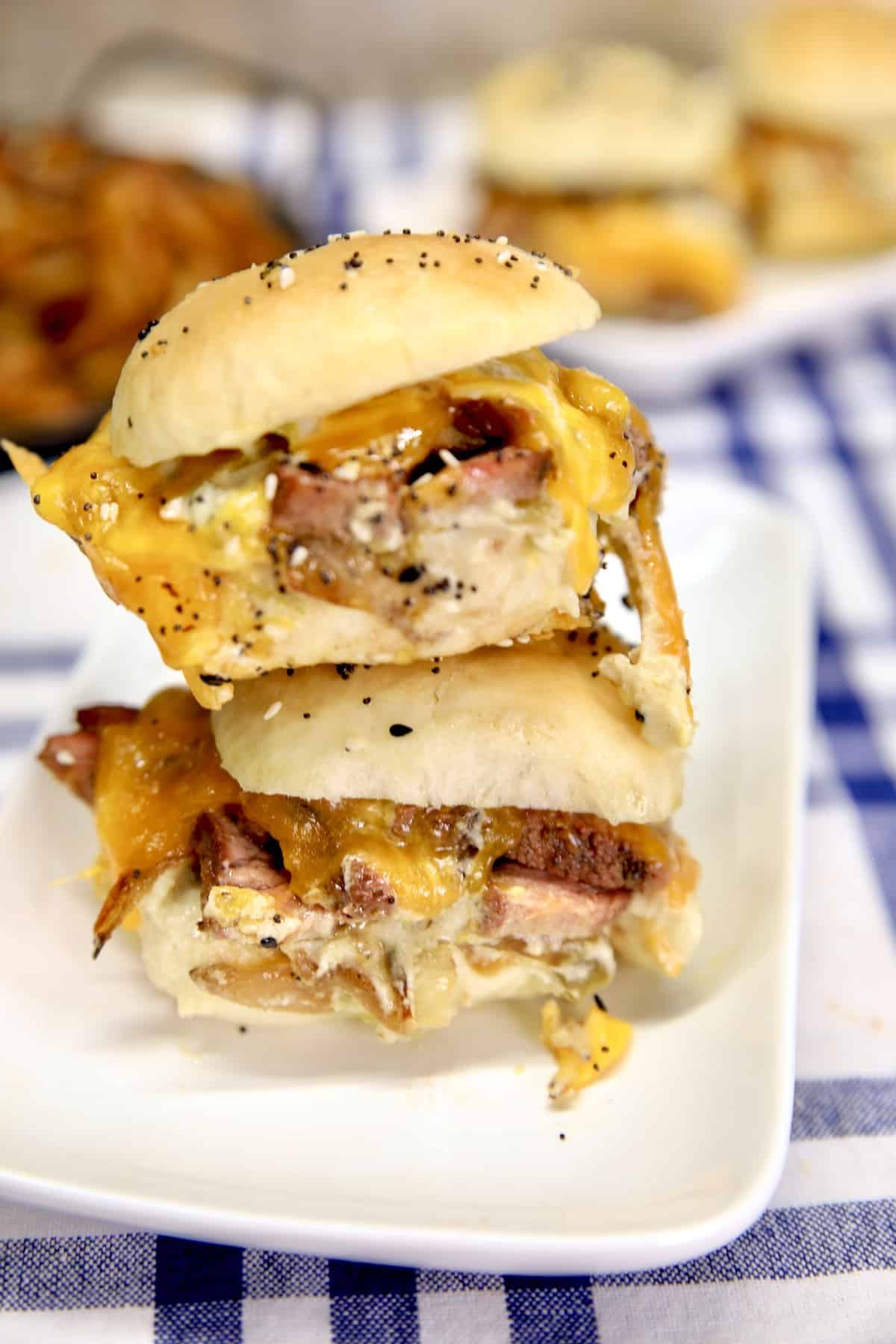 2 stacked steak sliders on a plate.