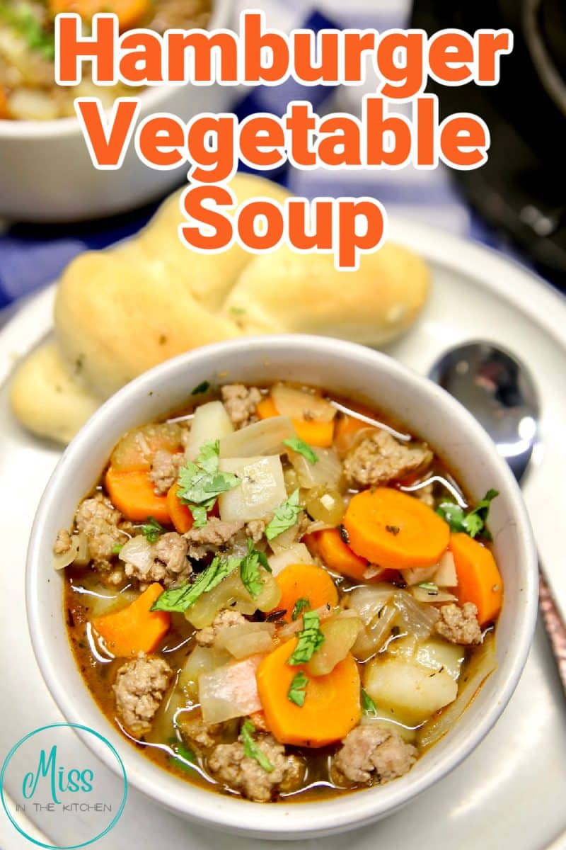 Hamburger vegetable soup in a bowl on a plate with roll, text overlay.