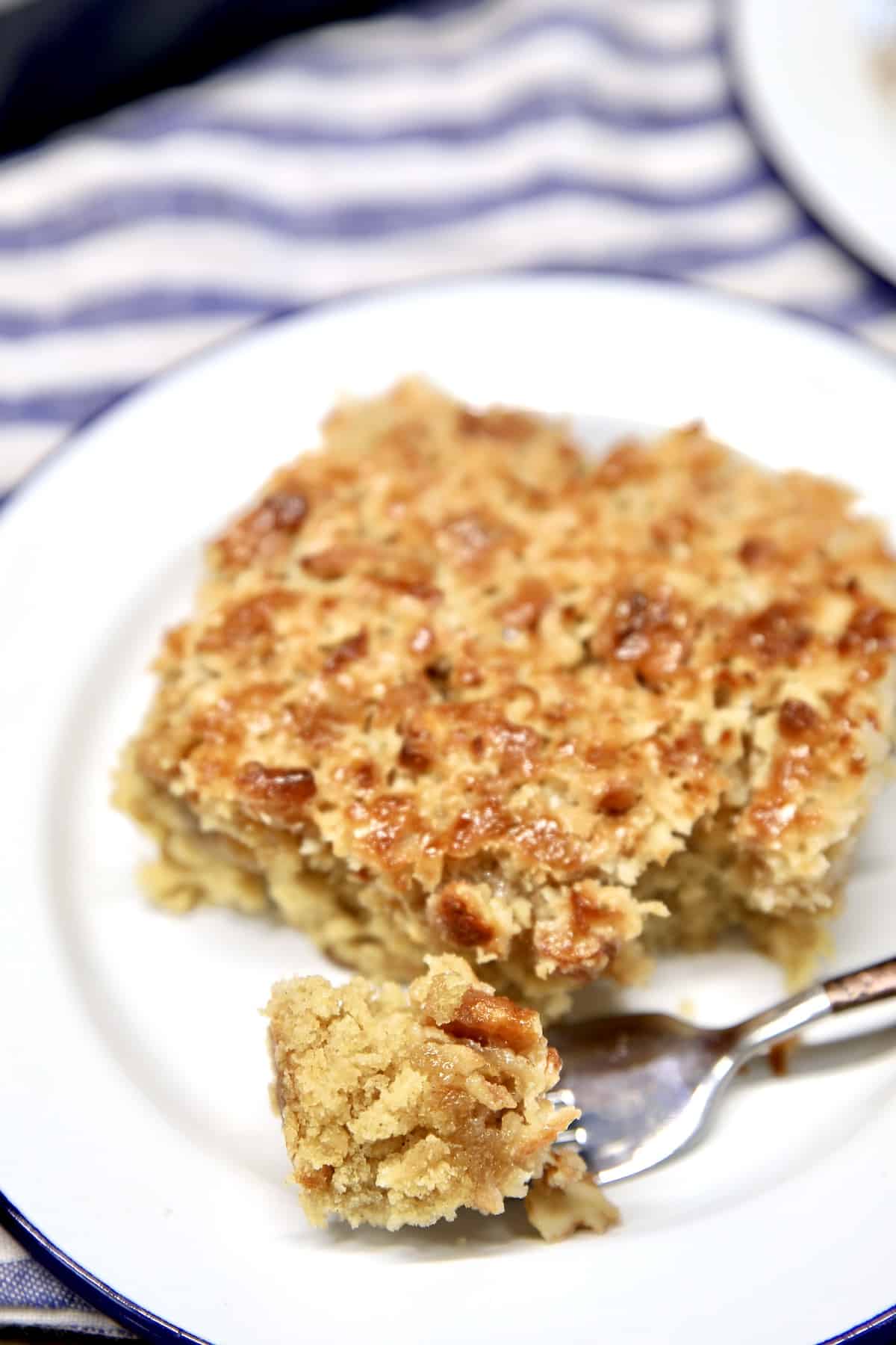 Slice of oatmeal cake on saucer, bite on fork.