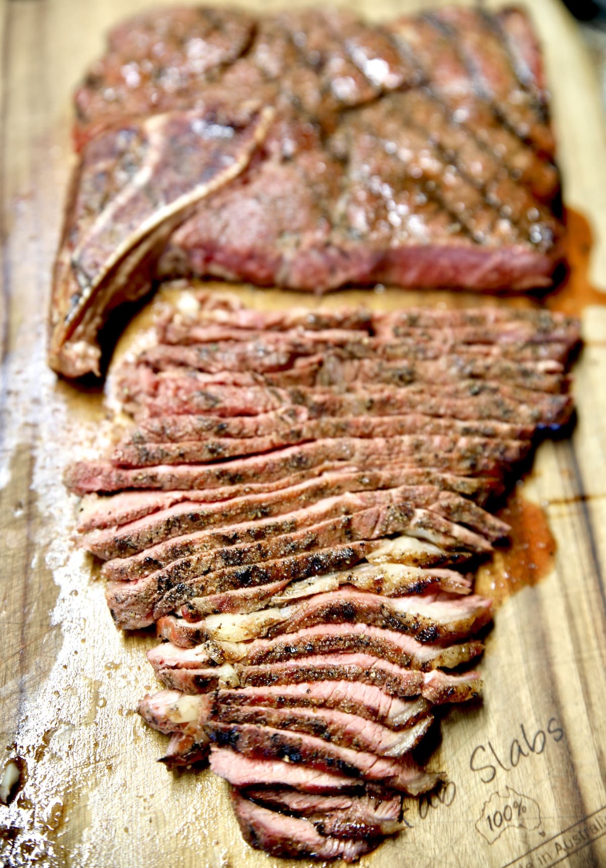 Sliced steak on a cutting board.